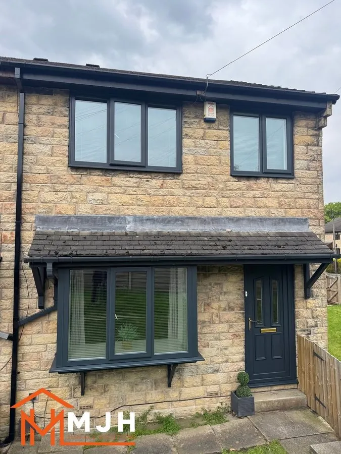 The same house with the door and frames sprayed anthracite grey